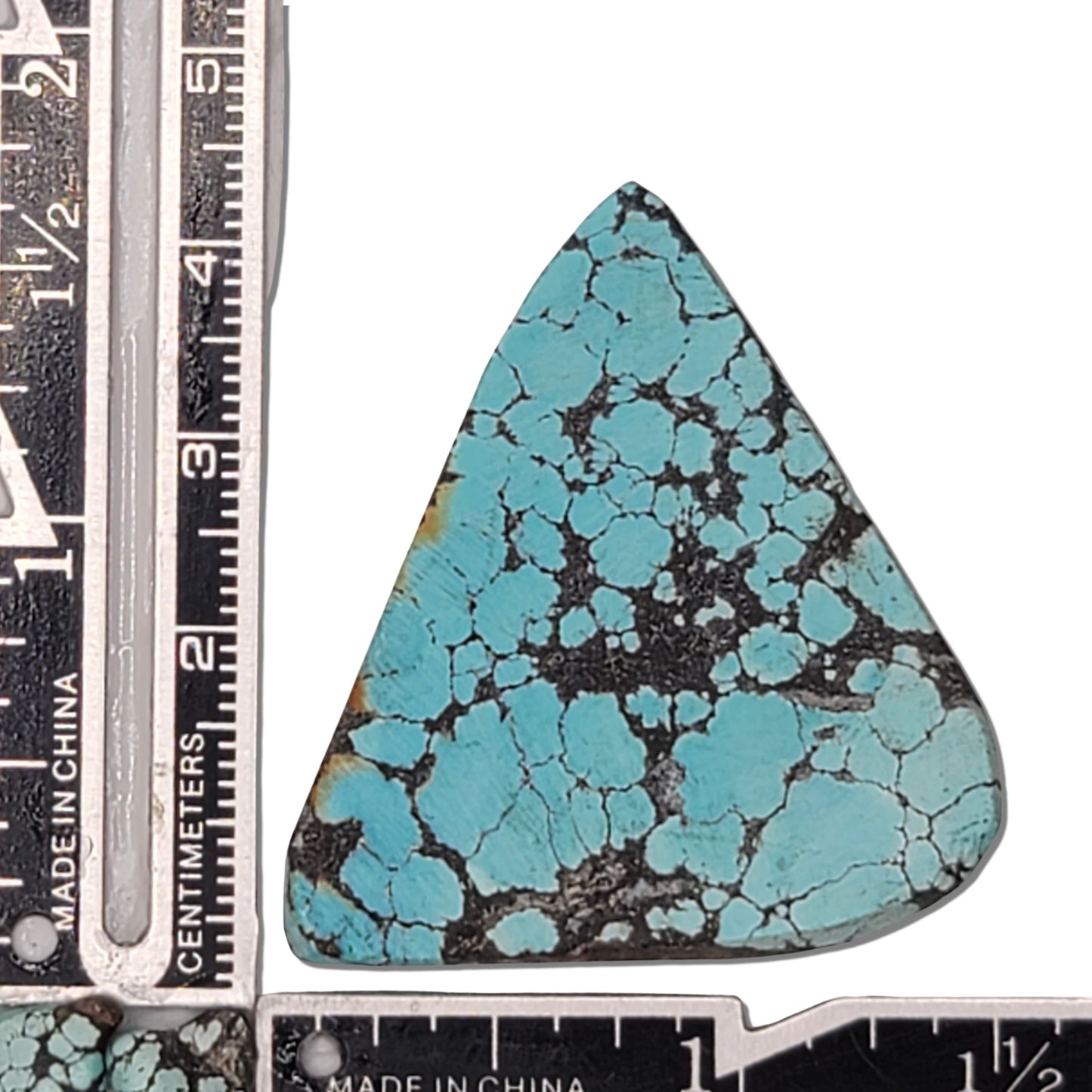 A 13-gram natural turquoise rough stone with a triangular shape, vibrant sky-blue color, and black webbing matrix. Ideal for jewelry design or lapidary projects, available at www.naturalturquoise.com.