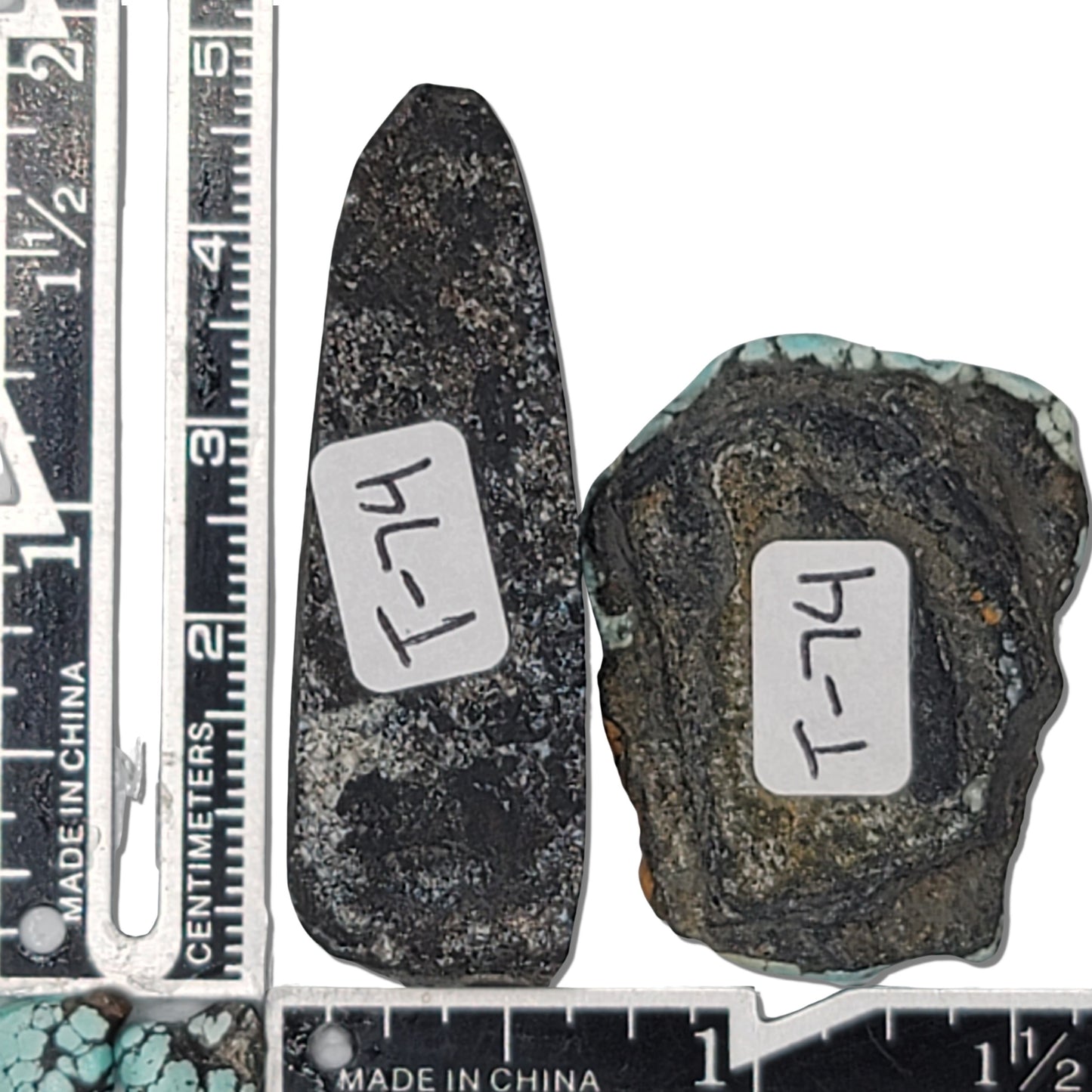A pair of natural turquoise stones weighing 21 grams, featuring vibrant blue tones with golden and dark matrix patterns. The stones measure approximately 5 cm x 2 cm and 3.5 cm x 3 cm, displayed with a ruler for scale. Available for purchase at www.naturalturquoise.com, ideal for lapidary and jewelry projects.
